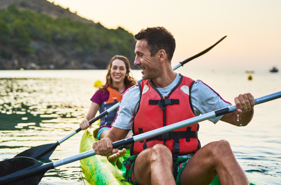 A picture of a couple kayaking on a lake