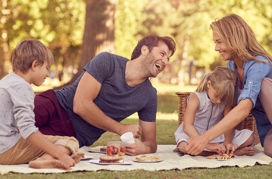 A picture of a family enjoying a picnic in a park