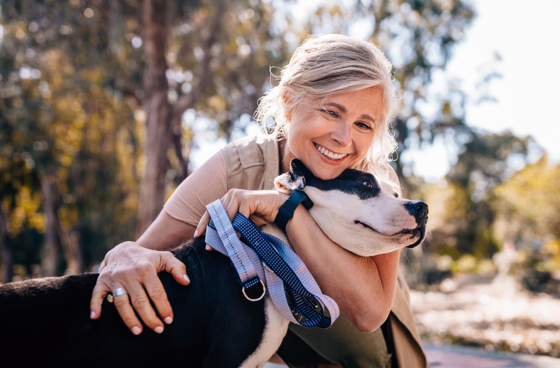 A picture of an older woman holding her dog