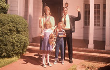 Family of four waving photo from 1950s era